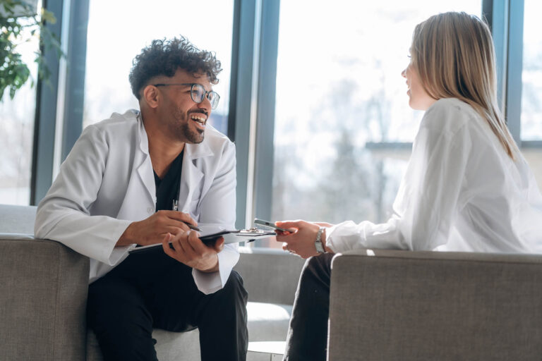 Thrive Mind & Wellness Center | Sitting and talking. Man and woman are indoors in modern building